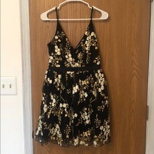 Express black, white, and gold embroidered flowers